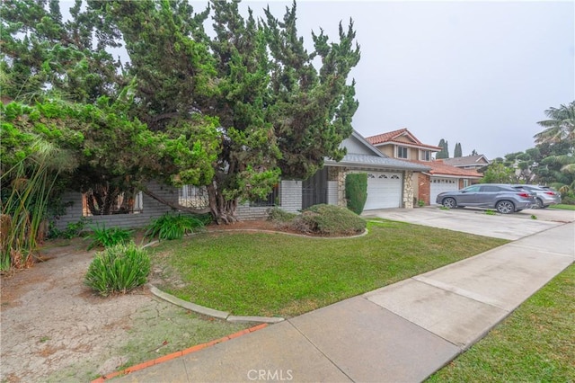 view of front of home with a front yard and a garage