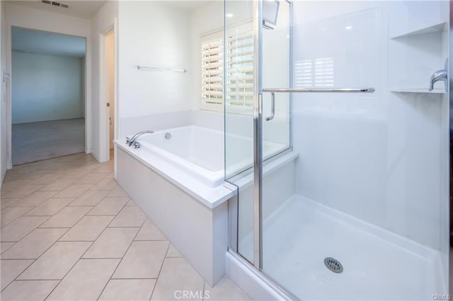 bathroom with tile patterned floors and independent shower and bath