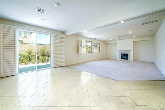 unfurnished living room featuring ceiling fan, light tile patterned floors, beam ceiling, and a fireplace