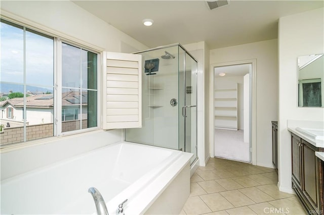 bathroom featuring tile patterned floors, separate shower and tub, and vanity