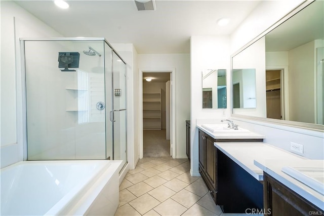 bathroom featuring shower with separate bathtub, tile patterned floors, and vanity