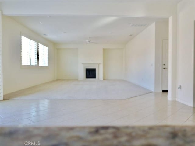 unfurnished living room featuring light tile patterned floors