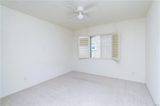 unfurnished room featuring ceiling fan and light colored carpet