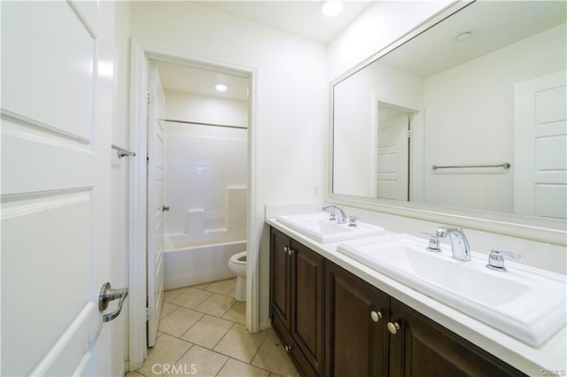 full bathroom featuring washtub / shower combination, vanity, toilet, and tile patterned flooring