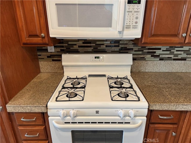 kitchen featuring white appliances, brown cabinets, and tasteful backsplash