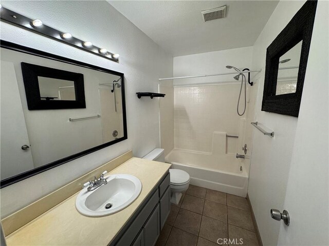 bathroom featuring tile patterned flooring, toilet, bathtub / shower combination, vanity, and visible vents