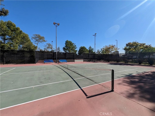 view of tennis court with fence