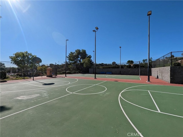 view of basketball court with community basketball court and fence