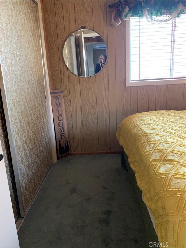 bedroom with wooden walls