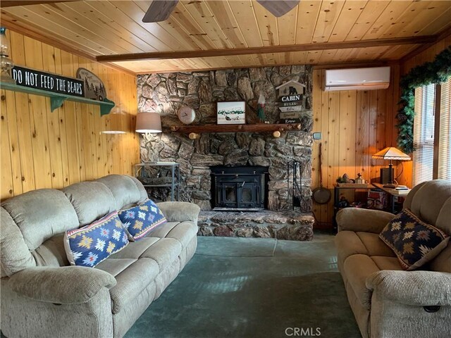 living room with an AC wall unit, wood ceiling, wooden walls, a wood stove, and ceiling fan