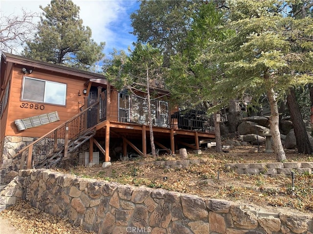 rear view of property with a wooden deck