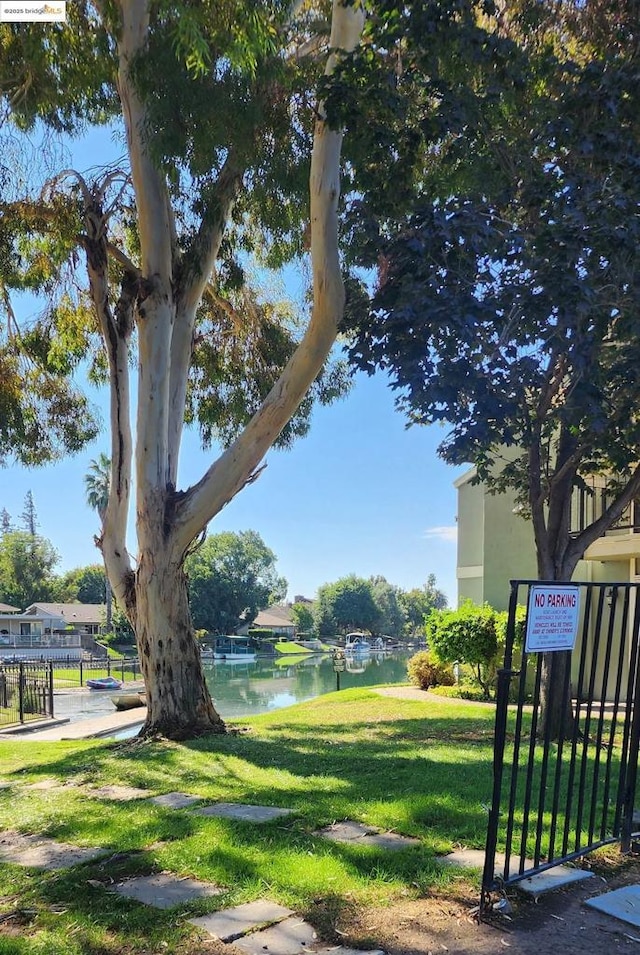 surrounding community featuring a yard and a water view