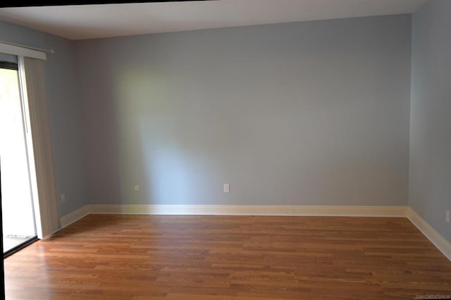 empty room with hardwood / wood-style floors