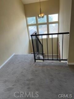 interior space featuring carpet floors and an inviting chandelier