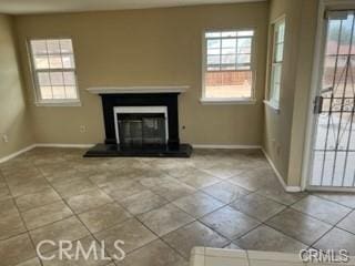 unfurnished living room featuring tile patterned floors