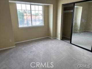 unfurnished bedroom featuring a closet and carpet