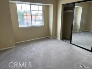 unfurnished bedroom featuring carpet and a closet