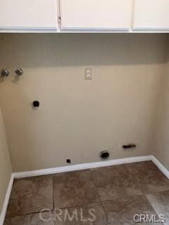 washroom featuring washer hookup, electric dryer hookup, and cabinets