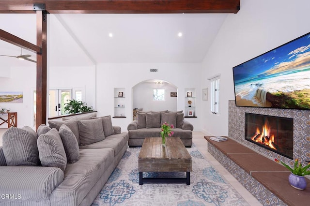 living room with ceiling fan and lofted ceiling with beams