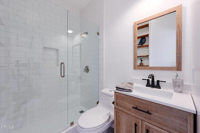 bathroom with toilet, vanity, and an enclosed shower