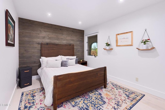 bedroom featuring wooden walls