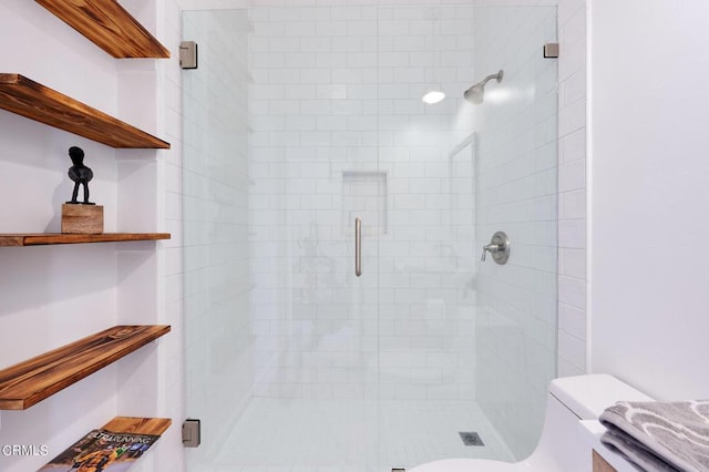 bathroom with toilet and walk in shower