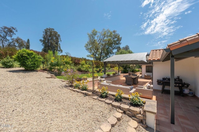 view of yard with an outdoor living space, a patio area, and a gazebo