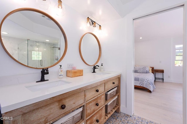 bathroom featuring walk in shower, hardwood / wood-style flooring, and vanity