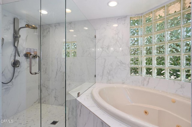 bathroom featuring shower with separate bathtub