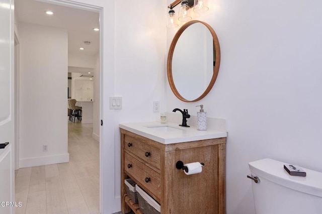 bathroom featuring toilet and vanity