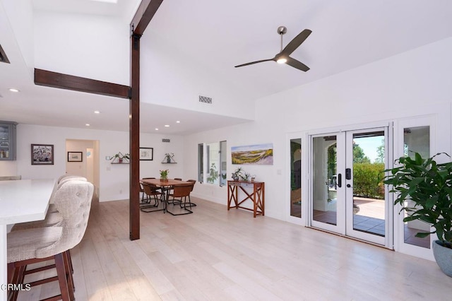 interior space with light wood-type flooring, ceiling fan, and french doors