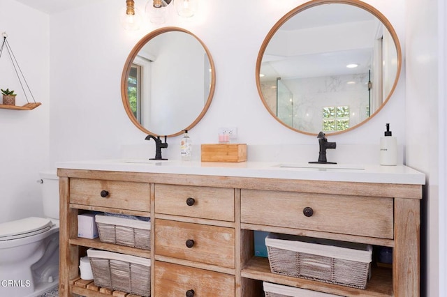 bathroom featuring toilet and vanity