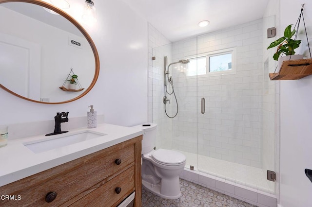 bathroom with toilet, walk in shower, and vanity