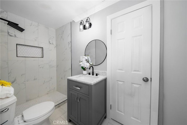 bathroom featuring crown molding, toilet, vanity, and a tile shower