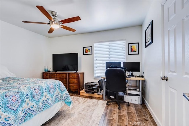 bedroom with ceiling fan and hardwood / wood-style flooring