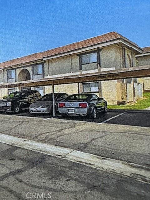 view of vehicle parking with a carport