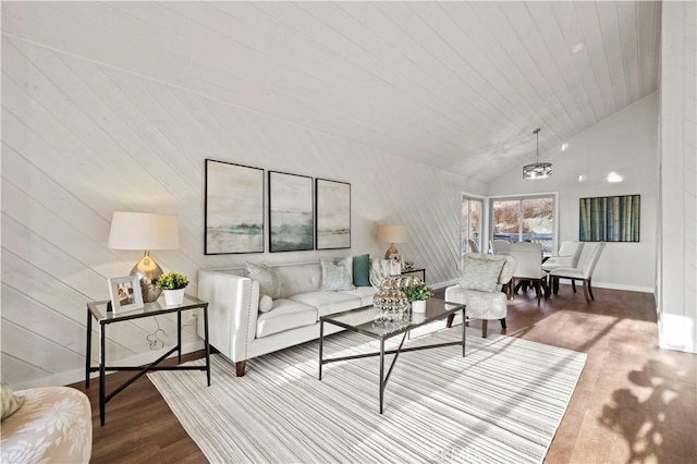 living area featuring vaulted ceiling, wooden ceiling, baseboards, and wood finished floors