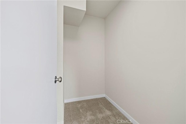 empty room featuring carpet flooring and baseboards