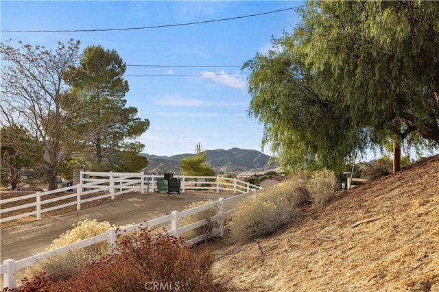 view of yard with a mountain view, a rural view, and fence