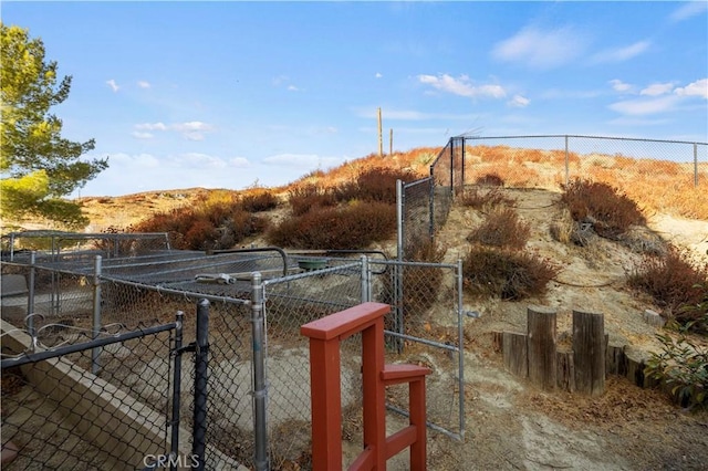 view of yard featuring fence and a gate