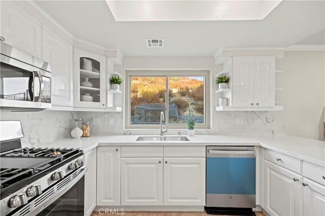 kitchen featuring visible vents, open shelves, a sink, appliances with stainless steel finishes, and white cabinetry