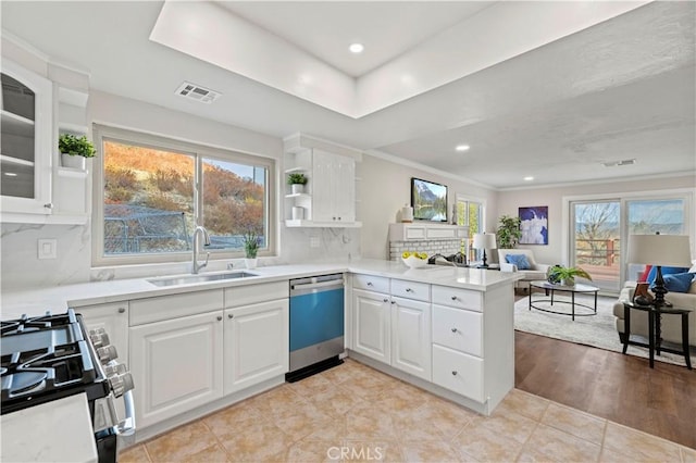 kitchen with visible vents, a sink, a peninsula, gas range, and dishwasher