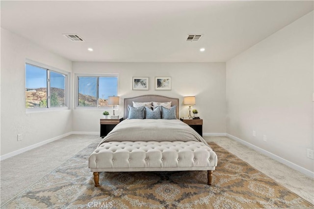 bedroom featuring visible vents, baseboards, and carpet