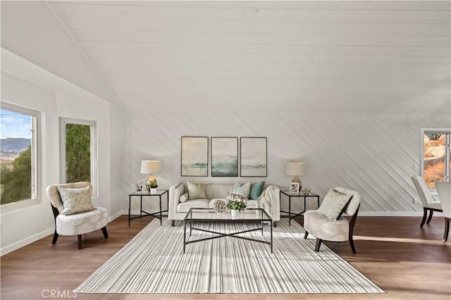 sitting room with lofted ceiling, wood finished floors, and baseboards