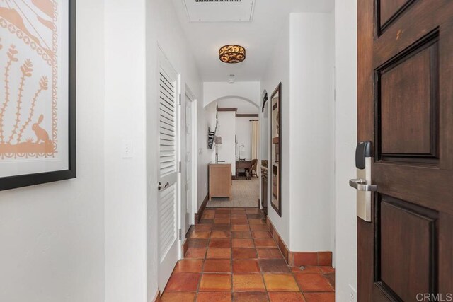 corridor with dark tile patterned flooring