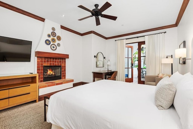 bedroom with french doors, crown molding, ceiling fan, access to exterior, and a tiled fireplace