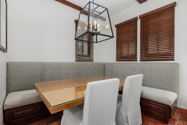 dining space with tile patterned flooring and a chandelier