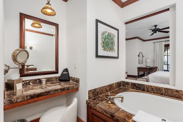 bathroom with crown molding, a bathing tub, and ceiling fan