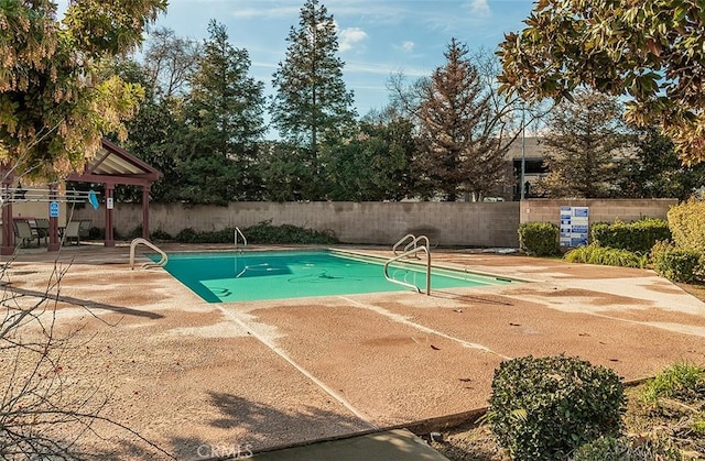 view of swimming pool with a patio