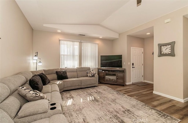 living room featuring hardwood / wood-style floors and vaulted ceiling